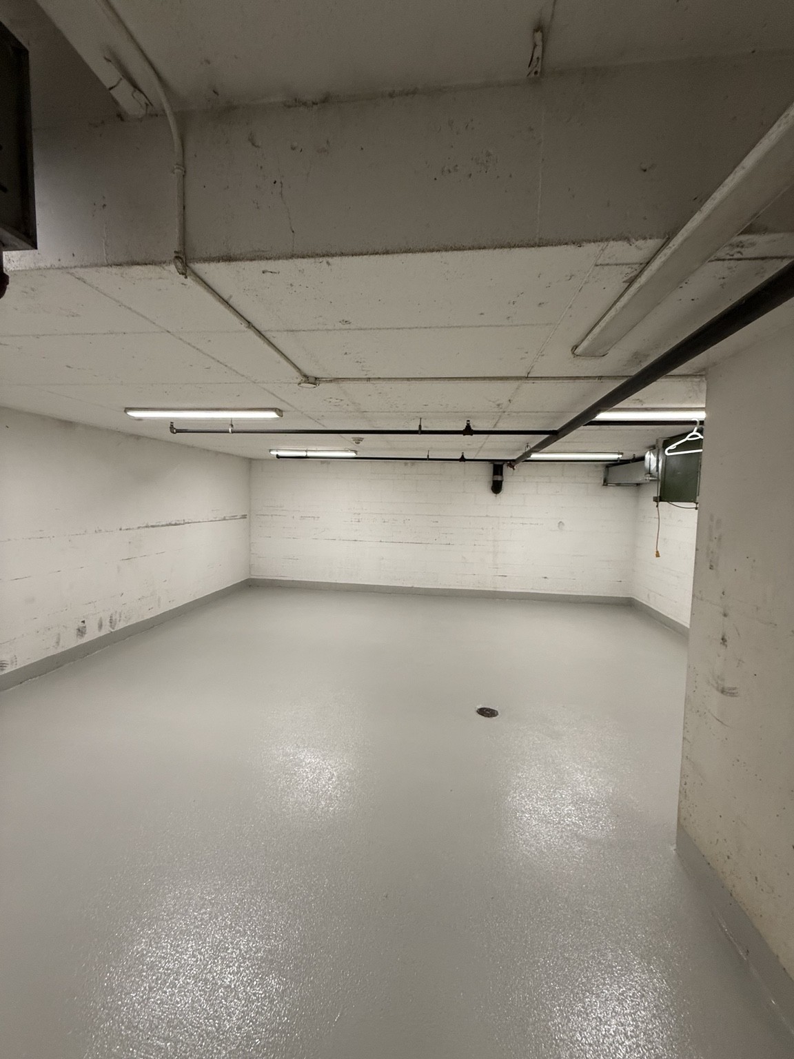 Completed textured grey floor with matching coated edges in a utility space